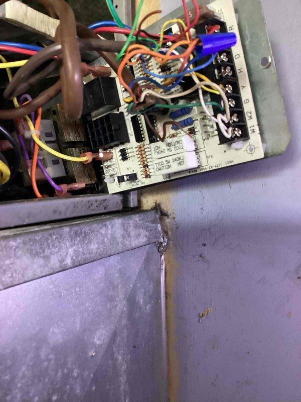 Responded to trouble call for air conditioning system with suspected capacitor failure. Performed diagnostic evaluation of electrical components and control board, inspecting all wire connections, terminals, and relays for proper operation. Documented equipment condition with photos showing control board, wiring configuration, and associated electrical components for service records.