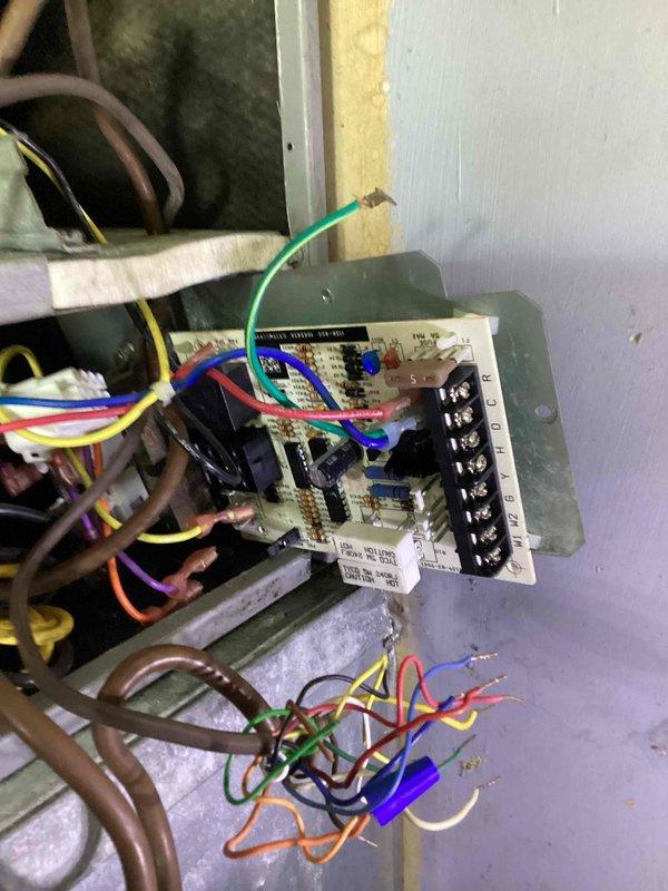 Responded to trouble call for air conditioning system with suspected capacitor failure. Performed diagnostic evaluation of electrical components and control board, inspecting all wire connections, terminals, and relays for proper operation. Documented equipment condition with photos showing control board, wiring configuration, and associated electrical components for service records.