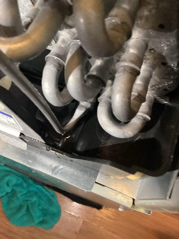 Responded to water leak complaint in laundry room area. Upon inspection, discovered heavy frost and ice accumulation on indoor evaporator coil assembly, with water leaking from drain pan onto floor. Diagnosed restricted airflow causing coil to freeze, resulting in condensate overflow when ice melted. Inspected outdoor condensing unit and verified proper operation. Cleared ice buildup, checked air filter and return air pathway, and restored proper drainage function to eliminate water leakage issue.