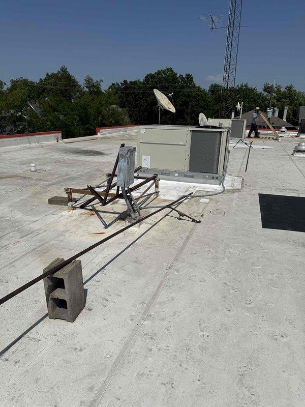 Completed commercial rooftop installation of three Daikin RTU units on flat membrane roof with proper equipment mounting and support structures. Installed concrete equipment pads, metal support frames, and electrical control panels with all necessary connections and technical specifications verified. All units positioned and secured according to manufacturer specifications with adequate clearances for service access and proper drainage considerations on existing roof surface.