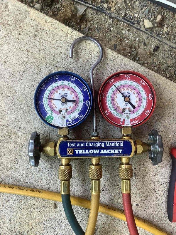 Responded to no cooling complaint with system running but discharging warm air. Connected manifold gauges to outdoor condensing unit and performed refrigerant pressure diagnostics to identify cause of insufficient cooling. System evaluated and pressures assessed to determine proper corrective action for restoring normal cooling operation.