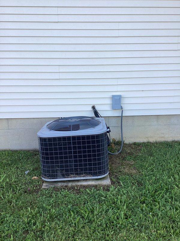 Completed tune-up and inspection on residential air conditioning system. Unit is currently operational, however discovered compromised electrical wiring from building to condenser unit showing significant deterioration and at risk of failure. Documented hazardous condition with photos and advised immediate repair to prevent loss of power to outdoor unit and potential safety concerns.
