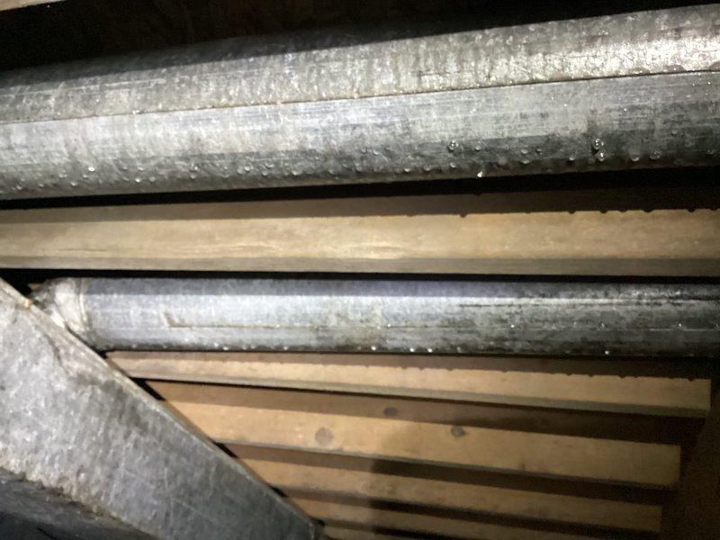 Returned to address excessive condensation on supply ductwork in crawlspace. Upon inspection, found heavy moisture accumulation and water droplets on metallic duct surfaces due to inadequate insulation and high humidity conditions. Documented existing conditions with photographs showing extent of condensation damage and potential for wood deterioration on adjacent floor joists. Recommended proper duct insulation upgrade and dehumidification solutions to prevent ongoing moisture issues and protect structural integrity of surrounding wooden framing members.