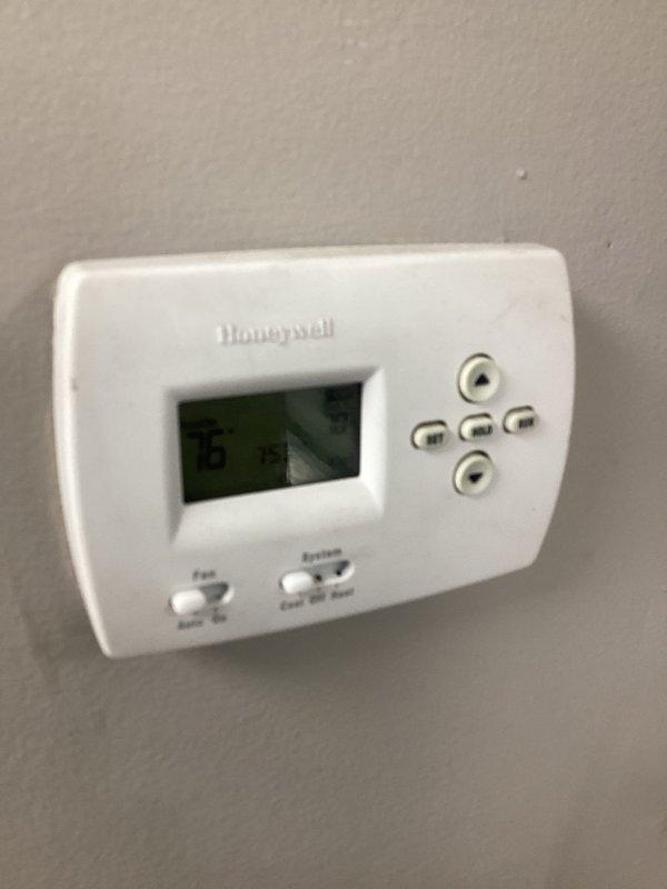 Responded to no cooling complaint for front retail area where thermostat was set to 71°F but space temperature had risen to 79°F. Upon inspection, discovered supply air temperature measuring 54.3°F at the duct, indicating the AC unit was producing adequate cooling. Identified thermostat location and programming issues preventing proper temperature control in the customer-facing zone. System operational with cold air being delivered to ductwork.
