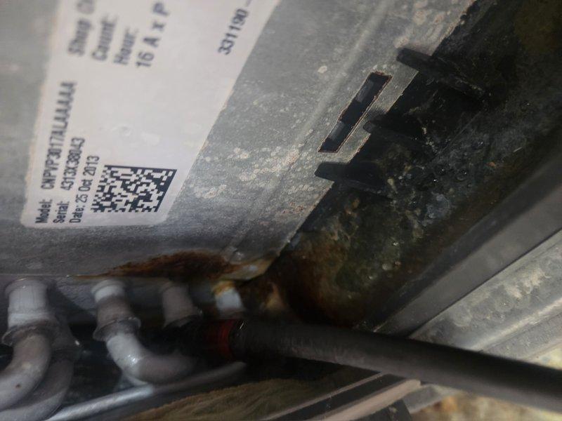 Responded to customer complaint of AC system running but not cooling adequately throughout residence. Upon inspection, discovered critical electrical fault with evidence of active arcing and overheating on wiring within air handler cabinet. Glowing orange-red spot observed on electrical conductor indicating dangerous heat buildup and potential fire hazard. System showed signs of age with rust accumulation and general wear on cabinet components. Documented equipment condition with photographic evidence of electrical failure and deteriorated internal components. Immediate shutdown of system recommended due to safety concerns until proper electrical repairs can be completed to resolve arcing issue and restore safe operation.