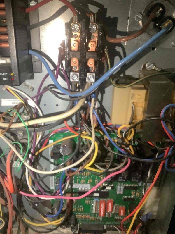 Responded to emergency no-cooling call at residential property. Upon arrival, performed diagnostic evaluation of HVAC system and inspected electrical control panel and circuit board assembly. Documented control board configuration, terminal block connections, and system wiring for electrical components including capacitor and safety controls with trip alert indicators.