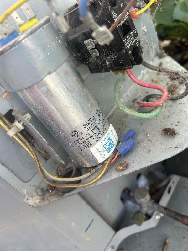 Responded to no cooling complaint on residential air conditioning unit. Upon inspection, found failed dual run capacitor with visible deterioration and compromised electrical connections. Replaced defective capacitor with new Turbo brand unit, cleaned debris and cobwebs from electrical compartment, secured all wire connections, and verified proper operation of contactor and compressor circuit. System tested and confirmed cooling operation restored with normal amperage readings.