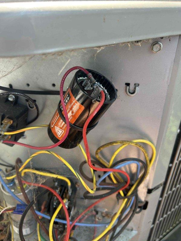 Responded to no cooling complaint on aging outdoor condensing unit. Upon inspection, found electrical control panel with disorganized wiring, aged capacitor, and contactor showing signs of extended service life and outdoor weathering. Inspected all electrical connections, tested capacitor for proper microfarad rating and voltage, and verified contactor operation. Evaluated condenser coil condition and overall system functionality. Unit restored to operational status with all electrical components functioning within specifications.