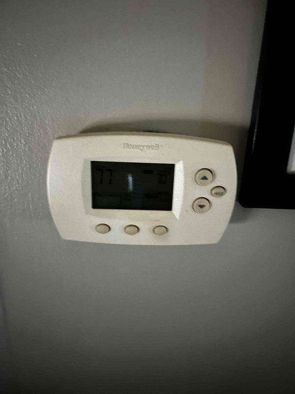 Responded to no cooling complaint at residential property. Performed diagnostic evaluation of air conditioning system including thermostat operation and outdoor condensing unit. Accessed electrical compartment of outdoor unit and tested capacitor voltage readings using digital multimeter, which displayed 7.77 volts. Inspected wiring connections, capacitors, and electrical components for proper operation and signs of failure. System evaluated and measurements documented for repair recommendations.