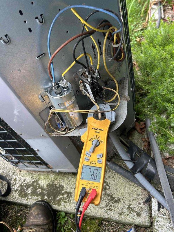 Responded to no cooling complaint at residential property. Performed diagnostic evaluation of air conditioning system including thermostat operation and outdoor condensing unit. Accessed electrical compartment of outdoor unit and tested capacitor voltage readings using digital multimeter, which displayed 7.77 volts. Inspected wiring connections, capacitors, and electrical components for proper operation and signs of failure. System evaluated and measurements documented for repair recommendations.