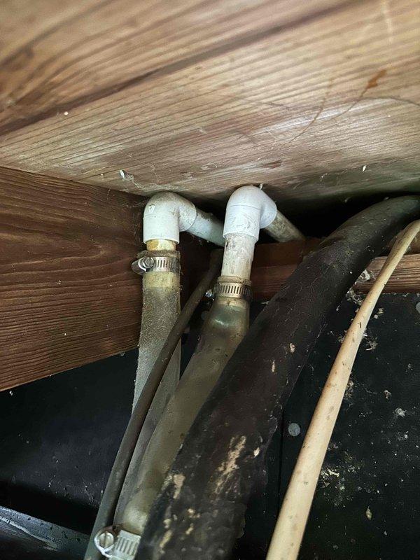 Returned to property to complete permanent repair of condensate drain line that was previously found disconnected above the soffit before entering the downspout. Coordinated with install manager to devise proper repair plan. Successfully reconnected and secured drain line connections using PVC elbows and stainless steel clamp bands to ensure proper drainage flow into downspout system. Documented completed repair with photos showing secured connections in crawl space area beneath deck structure.