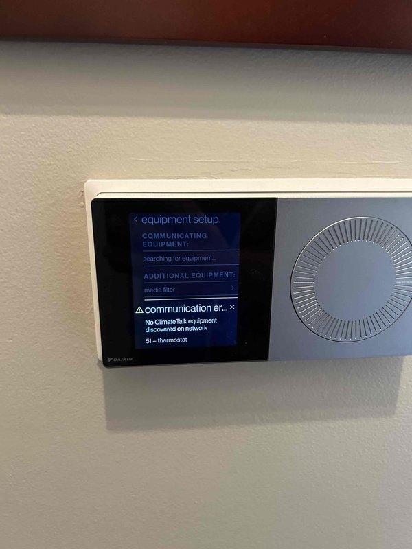 Responded to service call for AC system unable to reach setpoint of 72 degrees and displaying communication error on Daikin thermostat. Upon arrival, found thermostat displaying "No ClimateTalk equipment discovered on network" error and "EEV open circuit (incorrect wiring or not connected)" system error. Diagnosed communication failure between thermostat and HVAC equipment preventing proper system operation and temperature control. Corrected wiring issue to EEV, restored communication between thermostat and equipment, and verified system now cycling properly to maintain desired temperature.