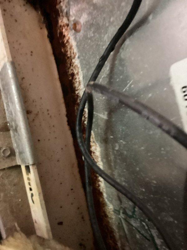 Responded to service call for AC unit leaking water from central compartment. Upon inspection, discovered condensate drainage issue causing water to drip past filter onto wooden surface below. Identified heavy rust accumulation along ductwork seam and deteriorated drain pan components contributing to leak when AC system operates. Performed necessary repairs to address drainage problem and prevent further water damage to surrounding area.