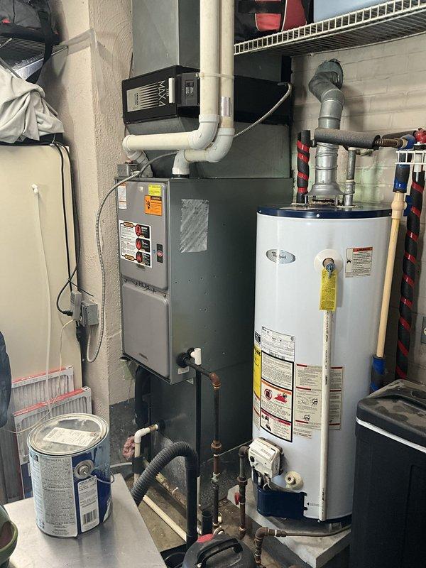 Conducted comprehensive assessment of existing HVAC system for replacement estimate. System evaluation revealed 20-year-old equipment including gas furnace and outdoor condensing unit that have reached end of expected service life. Documented current equipment specifications, installation configuration, and site conditions through detailed photography of indoor furnace unit with associated venting and outdoor condenser placement. Provided homeowner with replacement options and recommendations for new high-efficiency heating and cooling system to improve comfort and reliability.