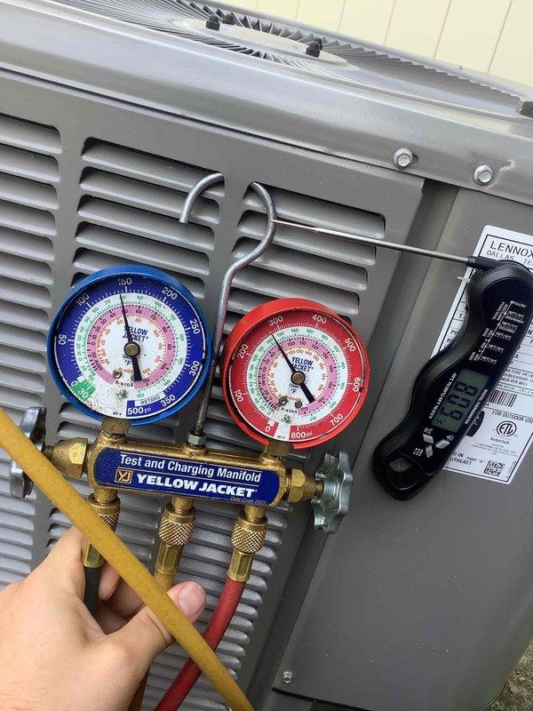 Responded to complaint of upstairs unit unable to maintain setpoint of 69°F, with temperature climbing to 71°F and continuing to rise throughout the day. Performed diagnostic evaluation of upstairs A/C system using manifold gauges to check refrigerant pressures and system performance. Conducted comparison testing between upstairs and downstairs units to identify performance discrepancy, as downstairs system maintaining proper temperature control without issue.