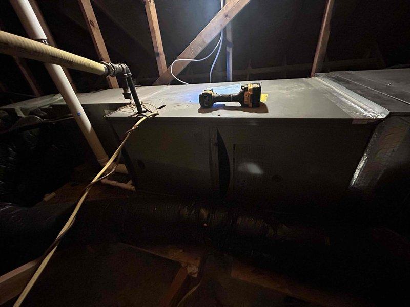 Responded to complaint of insufficient cooling from one of two HVAC systems at the property. Inspected attic-mounted air handler unit and outdoor condenser units positioned side by side on concrete pad. Performed diagnostic testing and system evaluation on the affected unit, which is less than 10 years old. Verified airflow, checked refrigerant levels, and assessed overall system performance to identify cause of reduced cooling capacity.