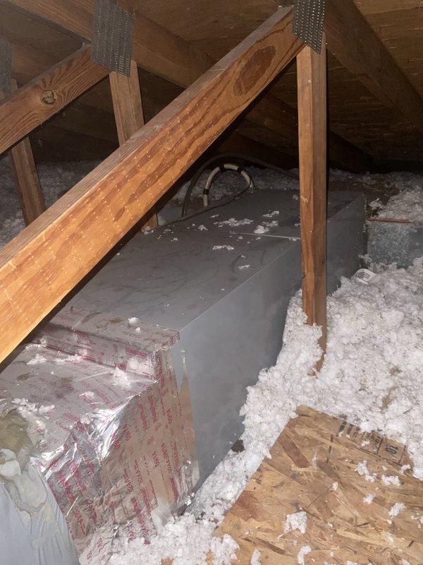 Conducted comprehensive site evaluation for cooling system replacement including assessment of existing outdoor condensing unit and attic air handler configuration. Evaluated ductwork modifications required for improved airflow distribution and identified need for secondary drain pan installation beneath attic-mounted air handler to prevent potential water damage. Documented current equipment specifications, electrical disconnect positioning, and accessibility considerations for replacement installation. Photographed existing system components and attic space conditions to develop accurate replacement proposal including equipment sizing, ductwork modifications, and drain pan integration requirements.
