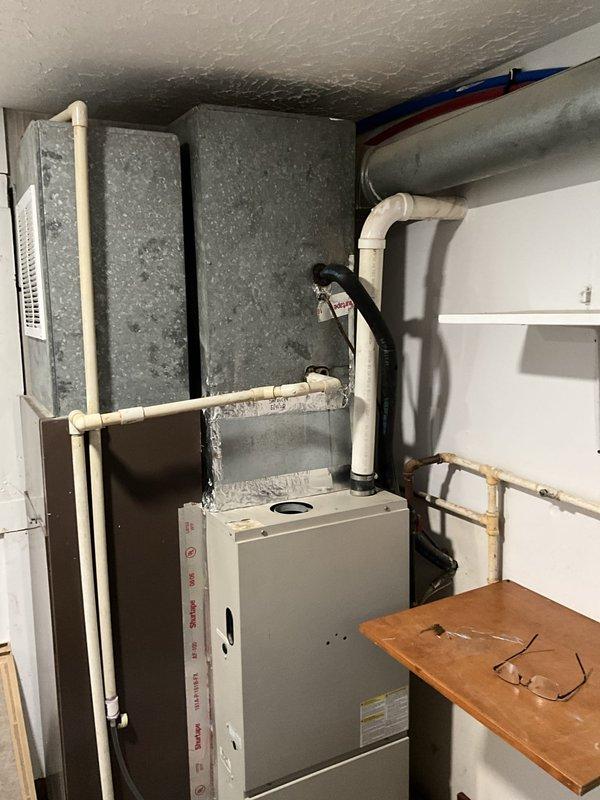 Completed estimate for full HVAC system replacement of aging equipment experiencing freeze-up issues during extreme heat conditions. Assessed existing indoor furnace/air handler unit in mechanical room and outdoor cylindrical condenser unit, both showing signs of age and declining performance. Provided replacement options to address system reliability concerns and prevent future breakdowns.