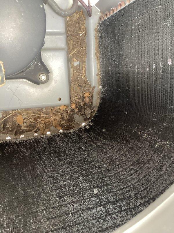 Responded to cooling complaint in office area reading 78 degrees. Upon inspection, found outdoor condenser coils heavily blocked with leaves, twigs, and organic debris restricting airflow and preventing proper heat exchange. Thoroughly cleaned evaporator coils, removed all accumulated debris from unit, and restored system to proper operating condition. Verified thermostat operation and cooling cycle functionality. Discussed preventative maintenance program enrollment with customer to prevent future issues.