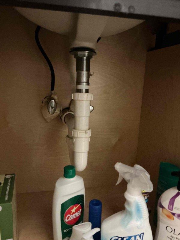 Completed prepaid plumbing inspection of residential property. Performed comprehensive visual assessment of accessible plumbing systems and components. Inspected under-sink plumbing assembly including white PVC P-trap configuration, drain pipe connections, and chrome stopper mechanism, confirming proper installation and compression fitting integrity. Examined basement or crawl space area, observing exposed piping, structural supports, and utility components. Documented all findings with photographic evidence for record-keeping purposes. All inspected plumbing components found to be functioning as intended with no immediate repairs required at time of visit.