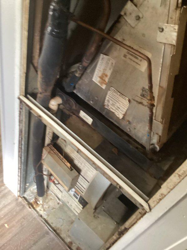 Responded to service call for air conditioning system blowing warm air. Upon arrival, found thermostat displaying 91°F with setpoint at 78°F and system actively calling for cooling. Inspected dual air handler units located in utility closet, noting significant dust accumulation on equipment surfaces and surrounding area. Performed system diagnostics and identified low refrigerant charge as primary cause of inadequate cooling. Recharged system to manufacturer specifications and verified proper operation of all components.