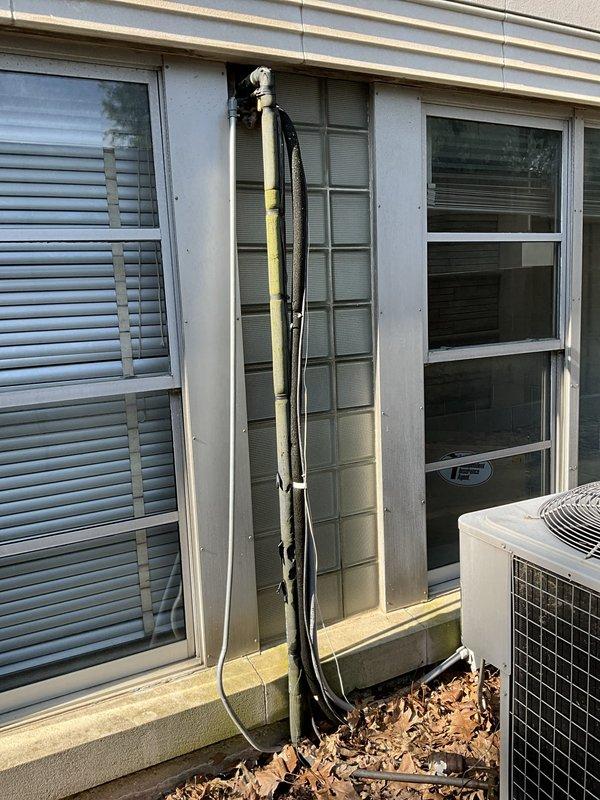 Provided estimate for replacement of non-functioning ceiling-mounted HVAC unit that is currently leaking. Documented existing outdoor condenser unit, refrigerant line set routing along exterior wall, and electrical connections for replacement specifications.