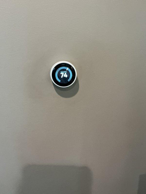Replaced defective dual-run capacitor rated at 70/10 MFD on residential outdoor condensing unit under warranty coverage. Removed failed capacitor, installed new unit, and verified proper electrical connections and system operation. Confirmed thermostat displaying correct temperature reading and system cycling properly upon completion.