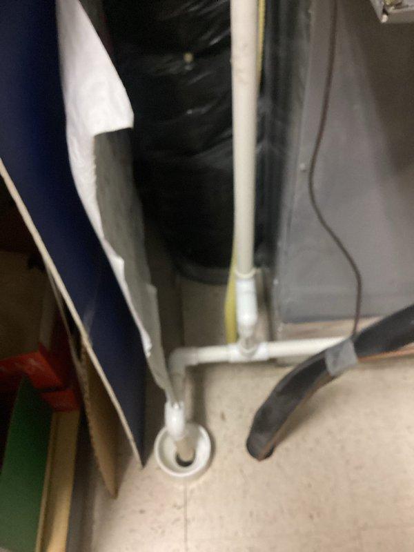 Responded to service call for HVAC system leak causing water intrusion through interior walls at commercial facility. Upon inspection, identified condensate drainage issue with system plumbing, documented existing conditions including water-damaged areas around drain lines and access points, and photographed mechanical infrastructure for assessment and recommended repairs.