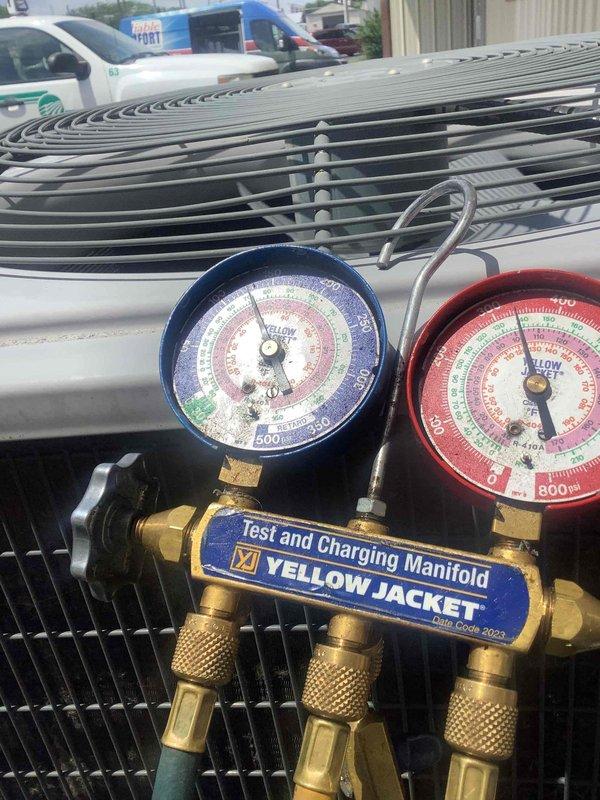 Responded to service call for air conditioning system with water discharge issue in utility area. Upon arrival, performed diagnostic evaluation of outdoor condenser unit and connected manifold gauges to assess system pressures and refrigerant charge levels. Cleared condensate drain line obstruction that was causing water overflow, verified proper drainage function, and confirmed system operational parameters were within manufacturer specifications.