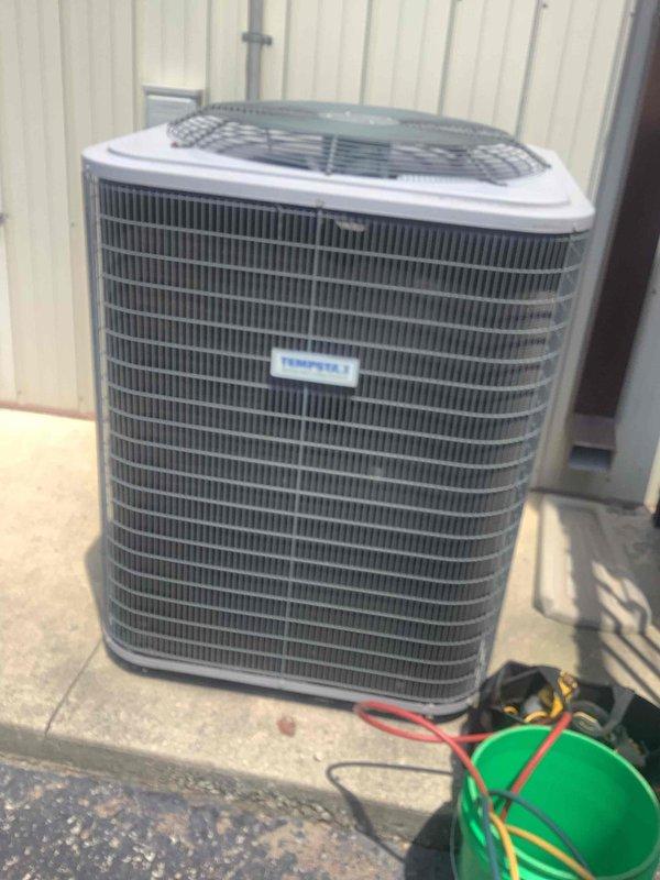 Responded to service call for air conditioning system with water discharge issue in utility area. Upon arrival, performed diagnostic evaluation of outdoor condenser unit and connected manifold gauges to assess system pressures and refrigerant charge levels. Cleared condensate drain line obstruction that was causing water overflow, verified proper drainage function, and confirmed system operational parameters were within manufacturer specifications.