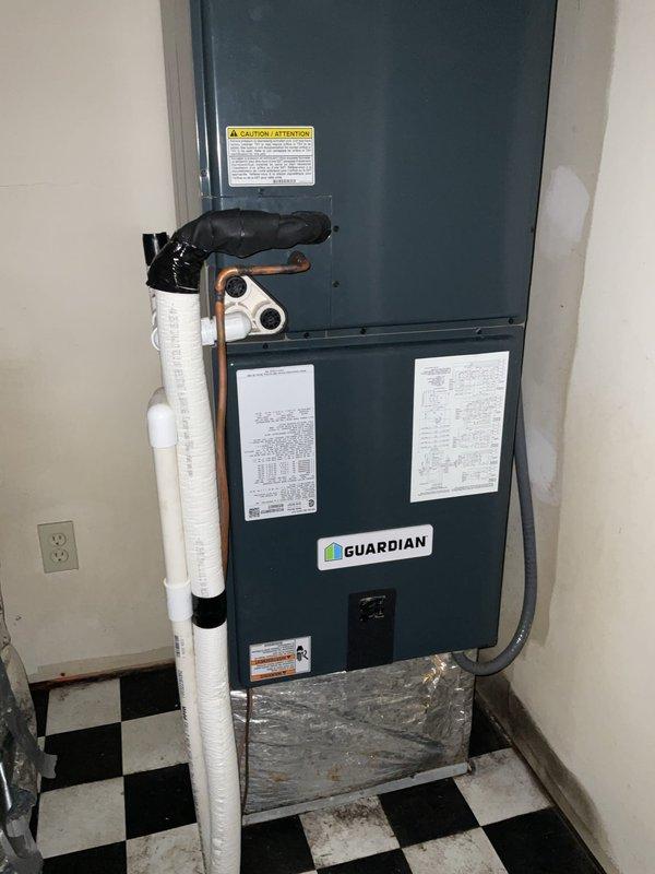 Responded to customer request for HVAC system replacement estimate after complete heat pump and air handler system failure. Assessed existing Guardian brand air handler unit installed in basement utility area with associated outdoor heat pump condenser unit positioned on concrete pad against exterior brick wall. Documented current equipment configuration including refrigerant line connections, electrical service, PVC drainage system, and overall installation condition through comprehensive site photography to provide accurate replacement system specifications and pricing proposal.