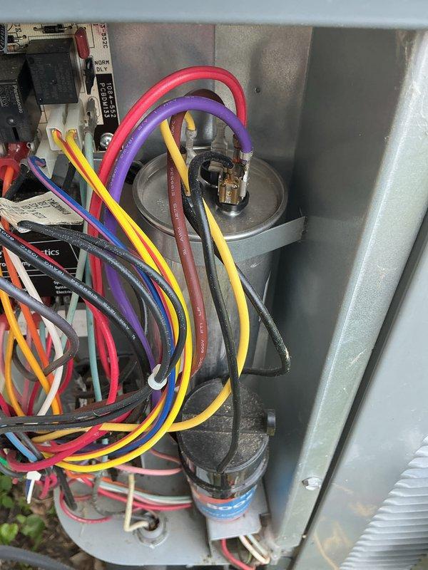 Performed cooling maintenance on system with unknown service history. Upon inspection, discovered evaporator coil heavily frosted with significant ice accumulation across serpentine tubing and heat exchange surfaces, indicating restricted airflow or potential refrigerant issue. Documented electrical panel configuration showing capacitor, control board, and associated wiring connections. Unable to locate or document existing air filter during inspection. System requires follow-up diagnostic to determine root cause of coil icing condition, which may include checking refrigerant charge levels, verifying proper airflow across coil, and investigating potential thermostat or control issues. Recommended immediate filter installation and monitoring of system performance.