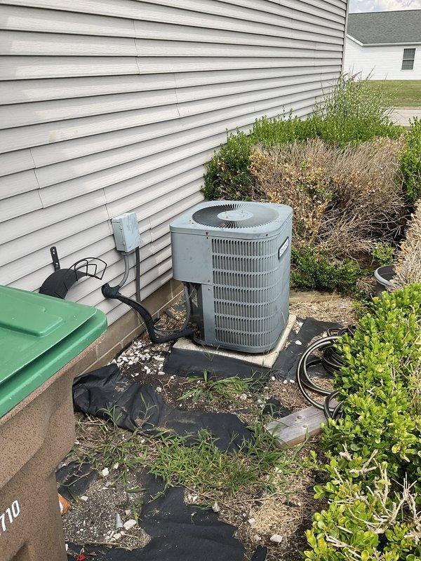 Performed comprehensive evaluation of 2006 R-22 air conditioning system experiencing compressor noise issues and intermittent cycling problems requiring power reset to restart. Assessed outdoor cylindrical condenser unit and indoor air handler, documenting equipment condition through photographic inspection. Recommended complete system replacement due to aging R-22 refrigerant system, deteriorating compressor performance, and history of recurring operational failures over the past two years.