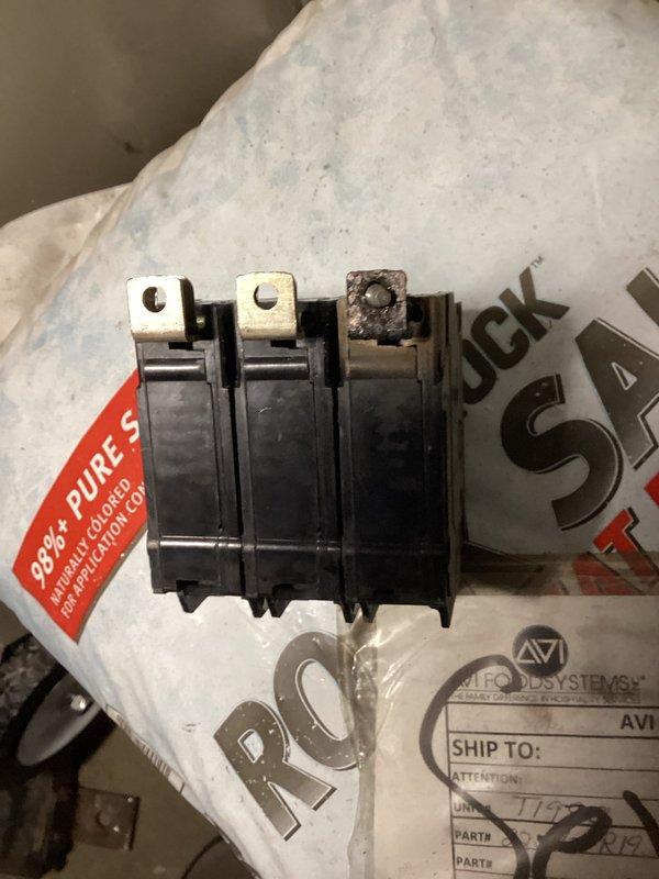 Replaced failed 30-amp three-pole circuit breaker serving commercial air conditioning unit in electrical panel. Removed damaged breaker exposing internal bus connections, installed new BR-type three-phase breaker, verified proper wire terminations, and restored power to AC system with all connections secure and operational.