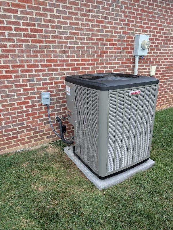 Completed full installation of Lennox heat pump system, model CBK48MVT-060-230-71, manufactured September 2020. Installed outdoor condenser unit on concrete pad against brick exterior with proper electrical disconnect and metering, ran refrigerant lines and electrical conduit from exterior wall to unit, and verified all electrical connections meet manufacturer specifications with maximum allowable pressure of 640 PSIG and static pressure testing at 0.50" WC. System fully operational and ready for service.