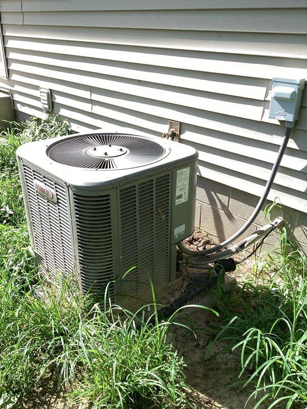 Completed basic monthly cooling maintenance on residential air conditioning system. Performed standard CCC protocol inspection of outdoor condensing unit, which showed signs of age with visible rust staining on lower cylindrical section and debris accumulation in louver vents. Installed 16x25x1 filter as part of routine maintenance service. System operational upon completion.