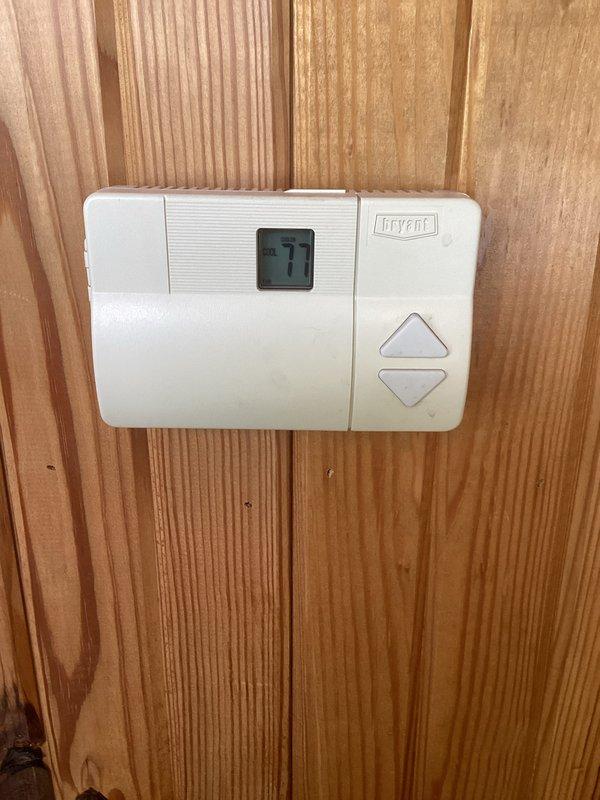 Performed routine cooling maintenance on residential Bryant HVAC system. Inspected outdoor condensing unit with cylindrical configuration, verified thermostat operation displaying 77°F, and documented filter status per customer's monthly maintenance agreement. All equipment operating within normal parameters.