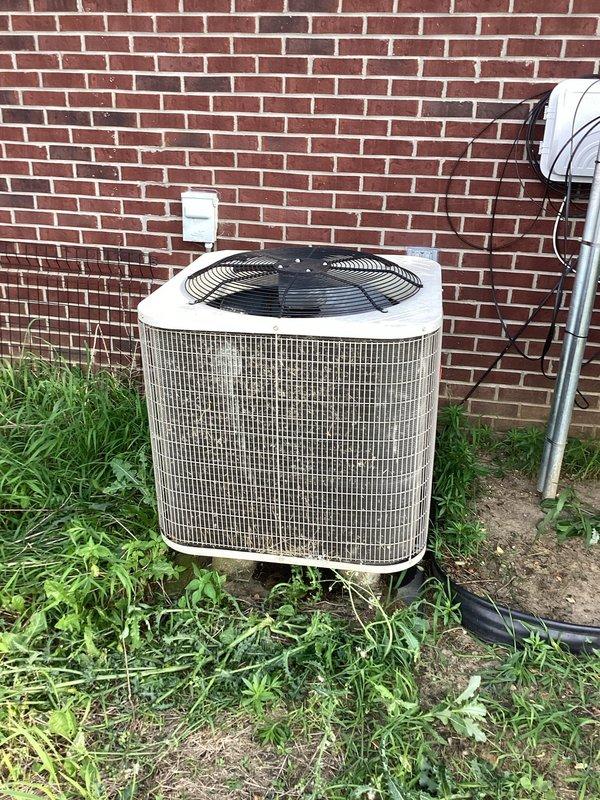 # HVAC Service Call - No Cooling Issue

Responded to a no cooling complaint on a Bryant system over 10 years old. Upon arrival, found outdoor condenser unit positioned against brick wall with vegetation growth around base restricting airflow. Inspected indoor air handler in basement utility room and outdoor condensing unit. 

Performed diagnostic testing on both indoor and outdoor components to identify cooling failure. Cleared vegetation and debris from around condenser base to restore proper airflow clearance. Evaluated refrigerant pressures, electrical connections, and compressor operation. Checked capacitor values, contactor condition, and verified proper voltage supply to outdoor unit.

Inspected indoor air handler for proper airflow, clean evaporator coil, and correct blower operation. System restored to operational status with cooling functionality confirmed before departure.