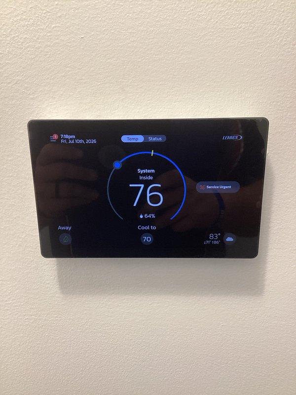 Responded to callback for recently installed HVAC system displaying "Service Urgent" alert on Lennox thermostat. Inspected air handler unit and ductwork assembly in mechanical room, verified proper installation and operation of equipment, and cleared service alert. System confirmed cooling properly to setpoint with normal humidity levels.