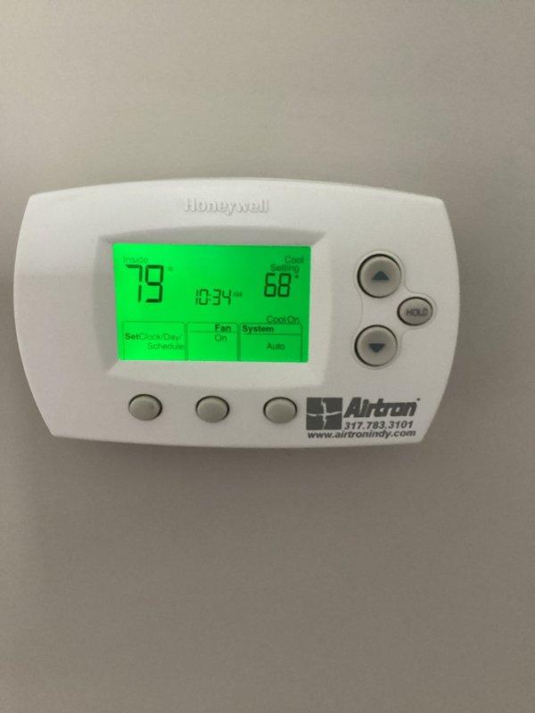 # HVAC Service Call - No Cooling Issue

Responded to no cooling complaint on residential HVAC system over 10 years old. Upon arrival, found Honeywell thermostat calling for cooling with display showing 79°F actual temperature and 68°F setpoint, with system status indicating "Cool On" mode. Inspected dark green air handler unit located in utility closet alongside water heater. Performed diagnostic evaluation of system components including electrical connections, refrigerant levels, and operational controls. Verified proper thermostat operation and communication with air handler. System restored to normal cooling operation and tested for proper cycling and temperature response.
