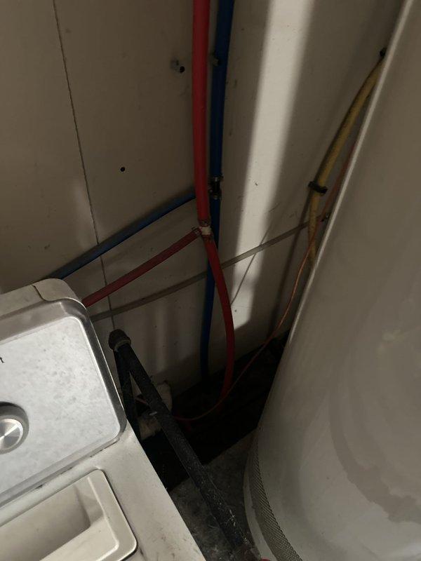 Responded to service call regarding black residue appearing at multiple water fixtures throughout the home, including kitchen and bathroom faucets, refrigerator water dispenser, and silicone surfaces. Conducted visual inspection of plumbing system and water heater in utility room to identify potential source of contamination. Documented mechanical room infrastructure including water heater, supply lines, and accessible plumbing components. Provided information on available water testing services to determine composition of black particles and discussed whole-home water filtration system options with preliminary estimates. Located and identified main water supply access points for potential filtration unit installation. Noted existing damage to drain pipe requiring future repair.