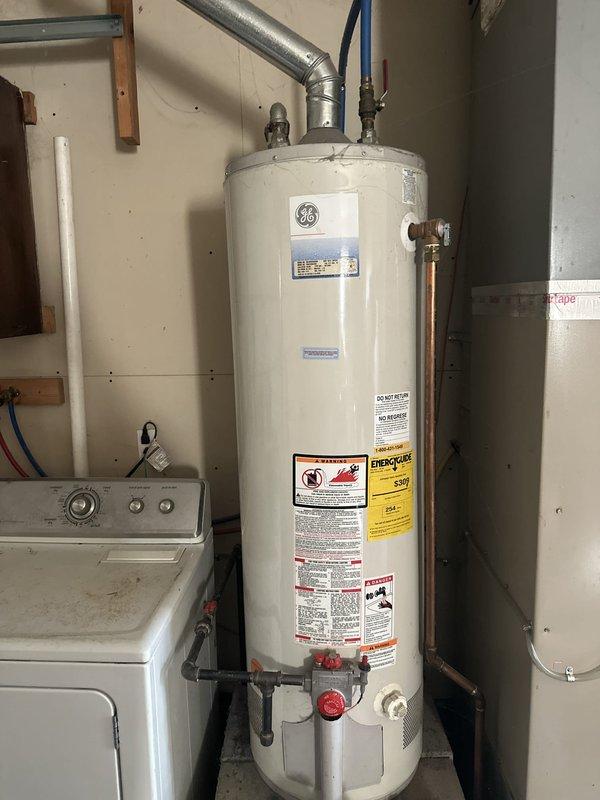 Responded to service call regarding black residue appearing at multiple water fixtures throughout the home, including kitchen and bathroom faucets, refrigerator water dispenser, and silicone surfaces. Conducted visual inspection of plumbing system and water heater in utility room to identify potential source of contamination. Documented mechanical room infrastructure including water heater, supply lines, and accessible plumbing components. Provided information on available water testing services to determine composition of black particles and discussed whole-home water filtration system options with preliminary estimates. Located and identified main water supply access points for potential filtration unit installation. Noted existing damage to drain pipe requiring future repair.