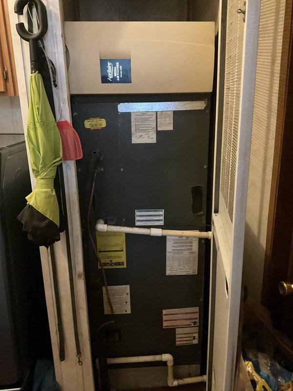 Conducted comprehensive evaluation of existing HVAC system in modular home experiencing refrigerant leak affecting both heating and cooling performance. System was determined to be non-functional due to significant refrigerant loss and unable to maintain proper temperature control. Inspected air handler unit located in interior utility closet and assessed exterior condensing unit positioned adjacent to home's deck area. Documented current equipment condition through photographic records showing weathered exterior siding, deck-mounted outdoor unit location, and interior air handler installation with existing PVC condensate drainage system. Provided detailed replacement estimate for complete HVAC system installation to meet program requirements for financial assistance application, ensuring proposed equipment and installation costs remain within specified budget parameters. Prepared documentation as one of three required competitive estimates for loan application submission.