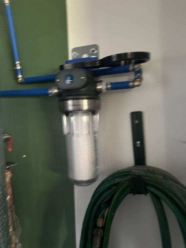 Responded to warranty service call for water filtration system installed in May. Removed over-tightened filter housing cap, replaced filter cartridge, and reassembled unit with appropriate torque to allow for future customer-performed filter changes. Verified system operation and confirmed housing cap can now be removed by hand for routine maintenance.