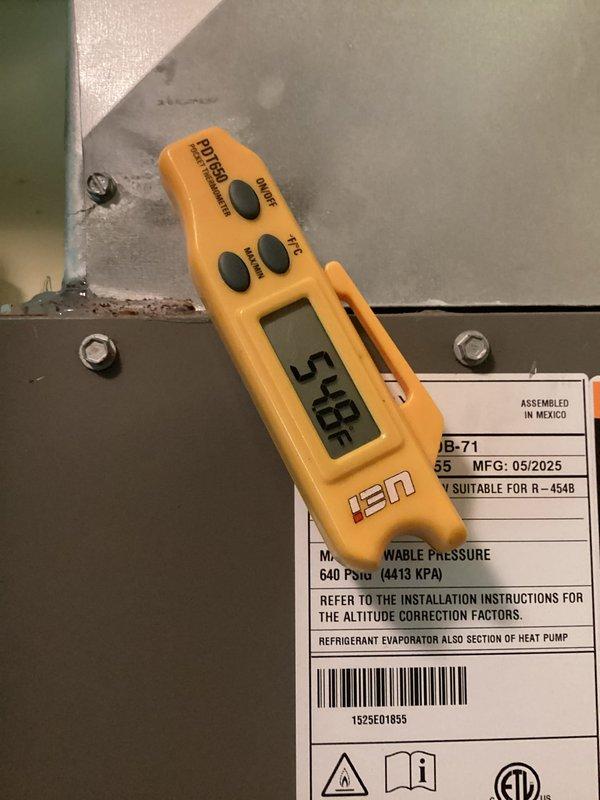 Responded to no-cooling call at vacant property where unit had frozen evaporator coil causing water damage to carpet. Upon arrival, found system thawed and confirmed proper superheat reading of 5.85°F on JB-71 model unit manufactured 05/2025, indicating system was operating within normal parameters. Verified thermostat settings and system functionality, confirmed unit cycling properly between heat and cool modes with no further issues detected.