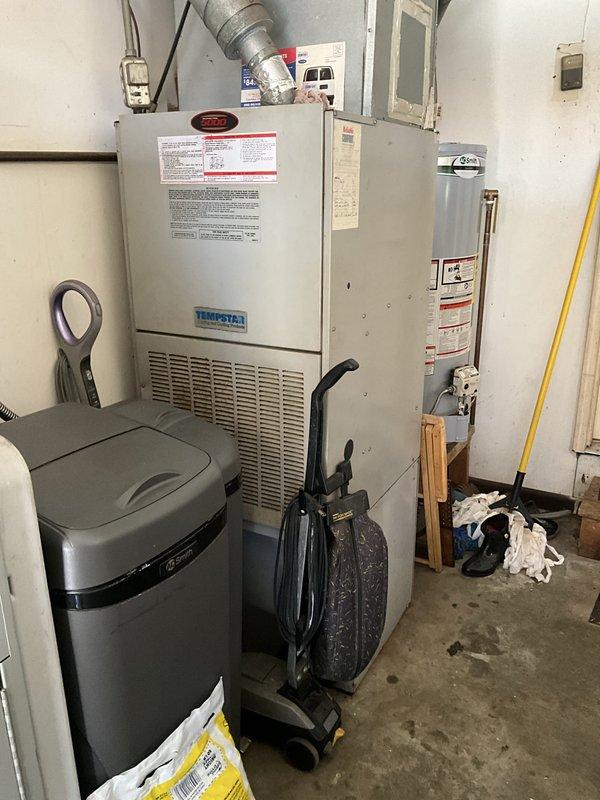 Responded to service call for air conditioning system low on refrigerant. Performed comprehensive evaluation of residential split system including Tempstar indoor air handler and outdoor condensing unit. Conducted visual inspection of both indoor and outdoor components, documented equipment condition through photographs, and assessed system age and overall operational status. Based on findings, provided estimate for complete cooling system replacement to address refrigerant loss and system reliability concerns.