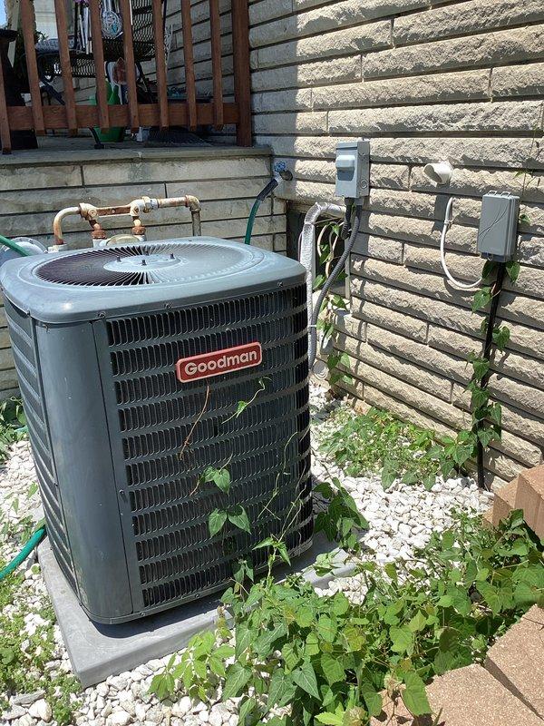 Completed routine maintenance on Goodman air conditioning system and heating equipment. Performed comprehensive AC tune-up including inspection of outdoor condensing unit, verified refrigerant line insulation integrity, and checked electrical disconnect components. Tested Honeywell programmable thermostat operation, confirmed cooling mode functioning properly at 74 degrees with fan set to auto mode. System operating within normal parameters with no issues identified during inspection.