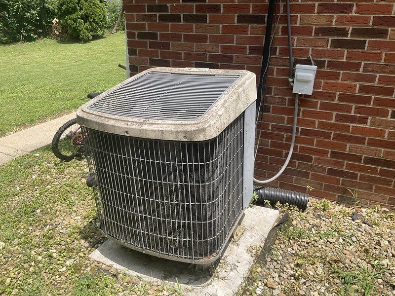 Technician responded to evaluate an aging air conditioning system that was no longer maintaining adequate cooling capacity and experiencing heating system issues. Upon inspection, the outdoor condenser unit showed significant wear with weathered components and dirt accumulation, while the indoor ventilation system was assessed for proper airflow distribution. A comprehensive replacement estimate was provided for a complete HVAC system upgrade to address both cooling and heating deficiencies.