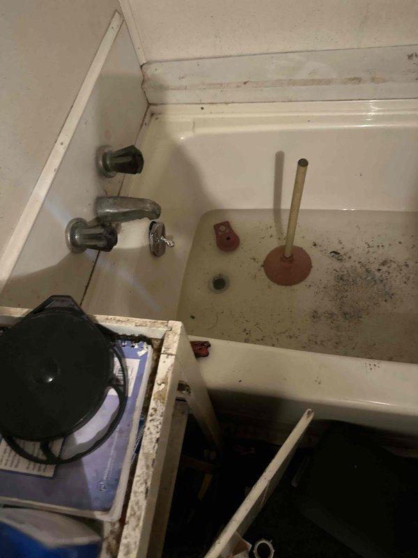 Responded to clogged drain line affecting utility sink and bathtub. Successfully cleared blockage in shared drainage line between fixtures using mechanical augering equipment. Restored proper drainage flow to both sink and tub, with all wastewater now evacuating normally through the system.