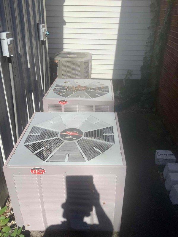 Responded to no cooling complaint in fellowship area. Inspected multiple King brand outdoor condenser units located along building exterior. Found accumulated leaves and debris on condenser fan grilles restricting airflow. Cleaned debris from affected unit, verified proper fan operation, and confirmed system returned to normal cooling operation.